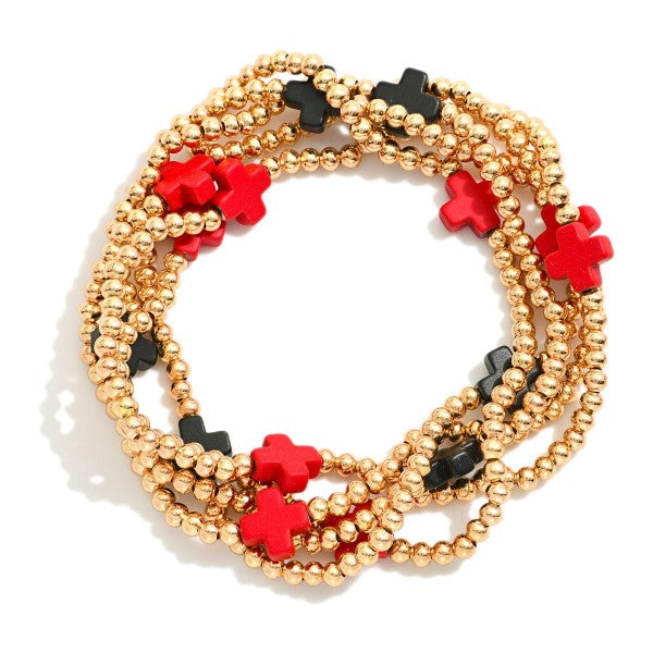 Set of 5 gold tone bracelets with red and black accents