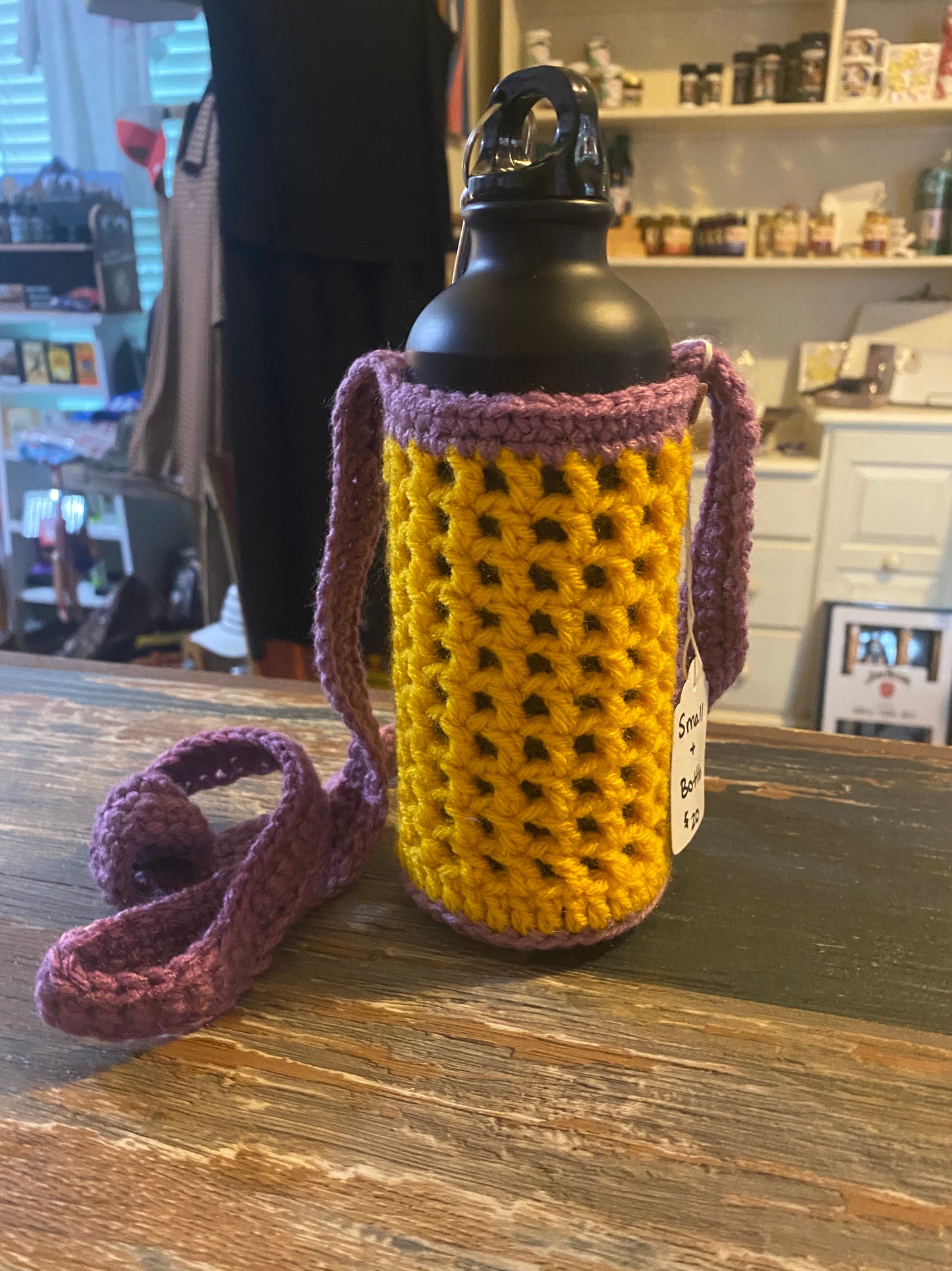 Kimani Created crocheted water bottle holder with water bottle